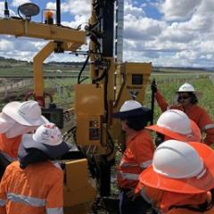 workers looking at construction equipment