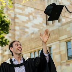 Kailin Graham in his graduation gown in UQ's Great Court